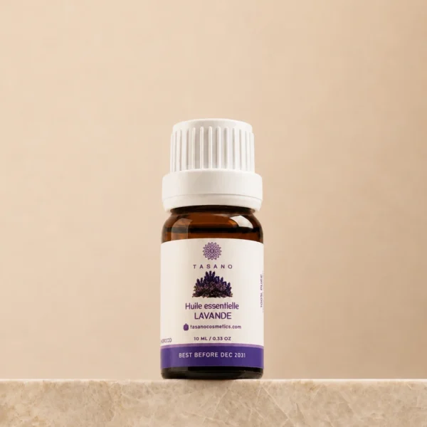 TASANO Lavender Essential Oil 10 ml bottle on beige marble pedestal, Moroccan aromatherapy oil in amber glass.