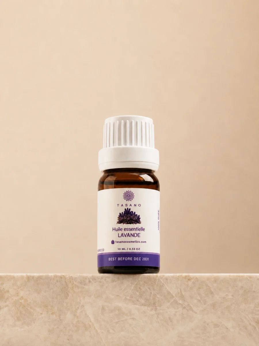 TASANO Lavender Essential Oil 10 ml bottle on beige marble pedestal, Moroccan aromatherapy oil in amber glass.