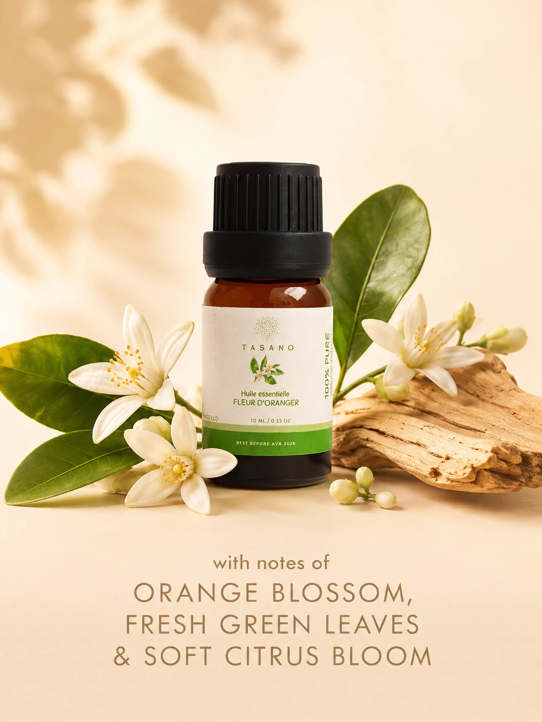 TASANO orange blossom essential oil bottle surrounded by orange blossom flowers in a fresh floral scent profile.