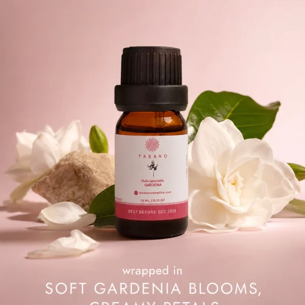 TASANO gardenia essential oil bottle surrounded by gardenia flowers in an elegant floral scent profile. TASANO gardenia essential oil bottle surrounded by gardenia flowers in an elegant floral scent profile.