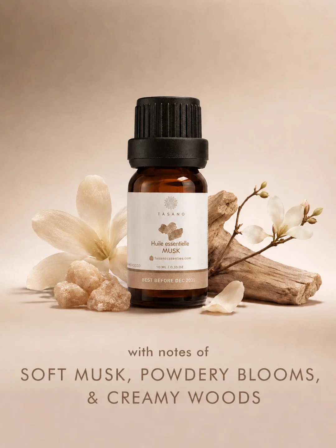 TASANO Musk essential oil bottle with soft musk stones, white florals and creamy woods on a warm neutral background showing its clean, comforting scent profile. TASANO Musk essential oil bottle with soft musk stones, white florals and creamy woods on a warm neutral background showing its clean, comforting scent profile.