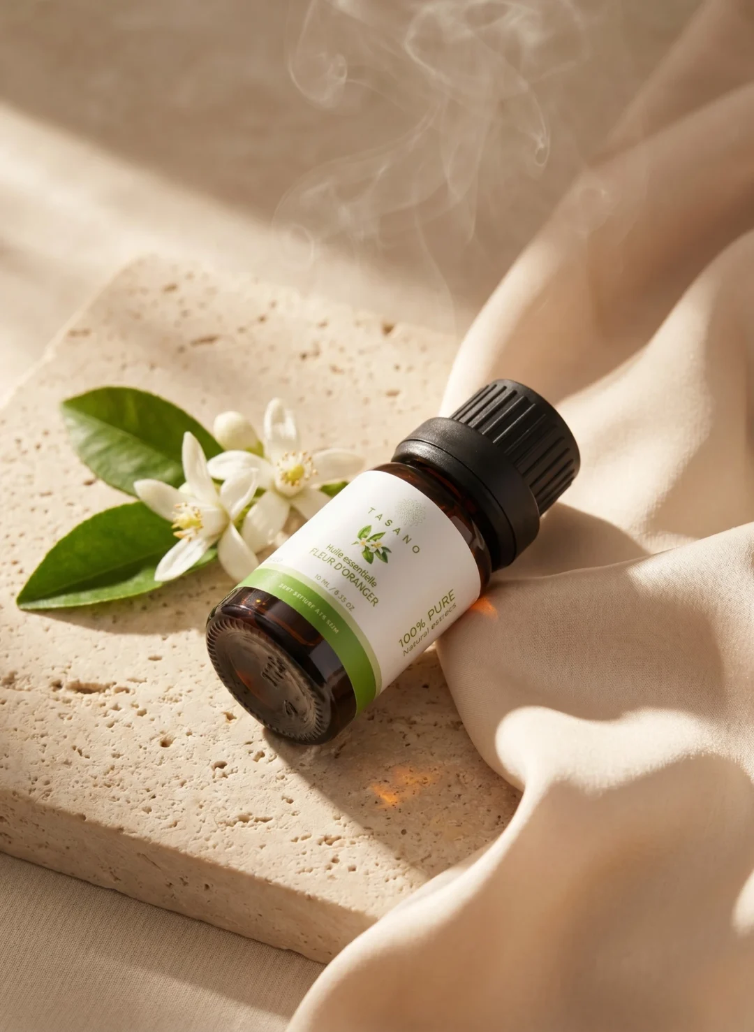 TASANO Orange Blossom Essential Oil styled with fresh orange blossoms, golden oil drops, silk fabric, and beige stone. TASANO Orange Blossom Essential Oil styled with fresh orange blossoms, golden oil drops, silk fabric, and beige stone.