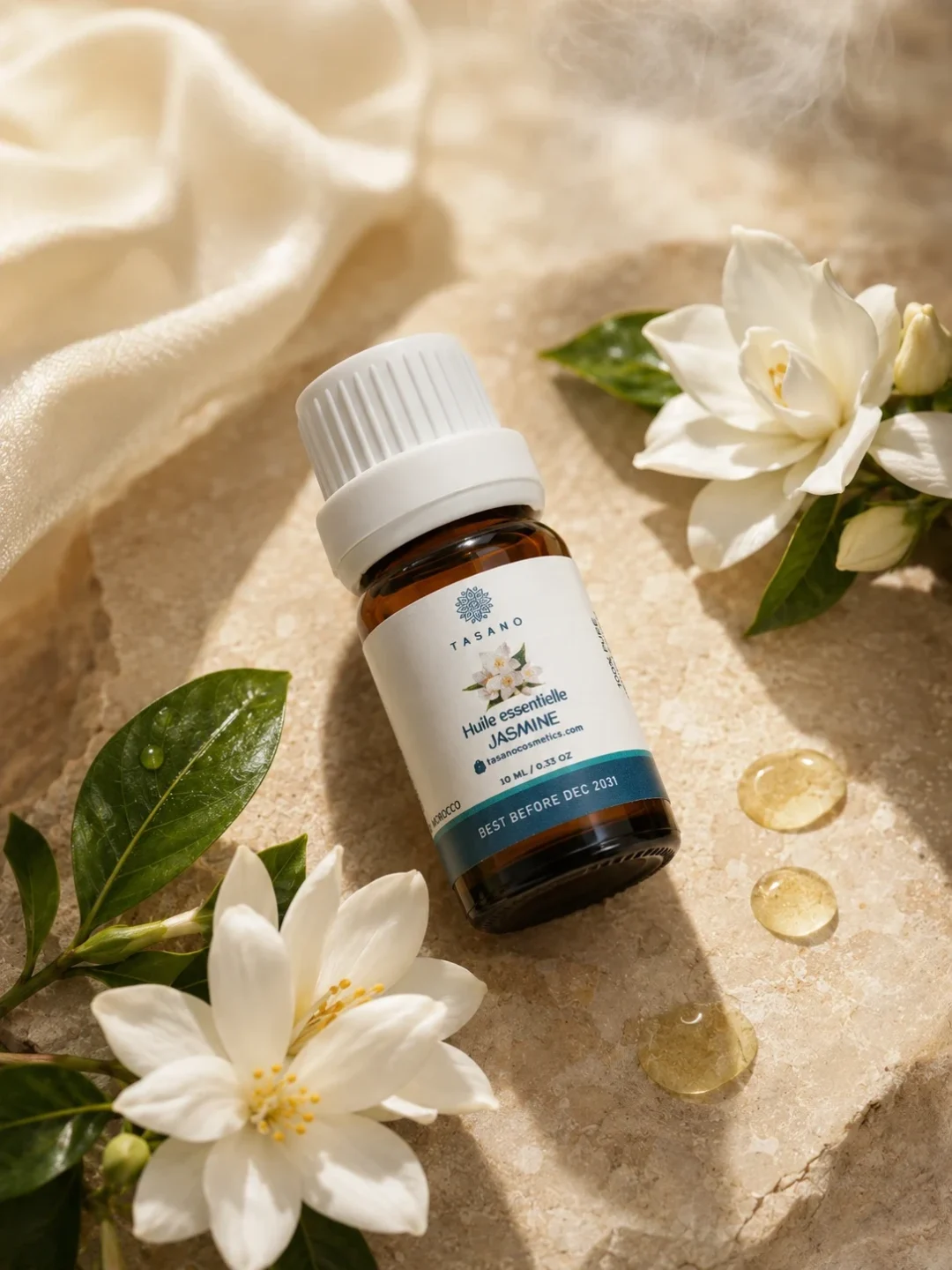 TASANO Jasmine Essential Oil styled with fresh jasmine flowers, yellow oil drops, silk fabric, and natural sunlight. TASANO Jasmine Essential Oil styled with fresh jasmine flowers, yellow oil drops, silk fabric, and natural sunlight.