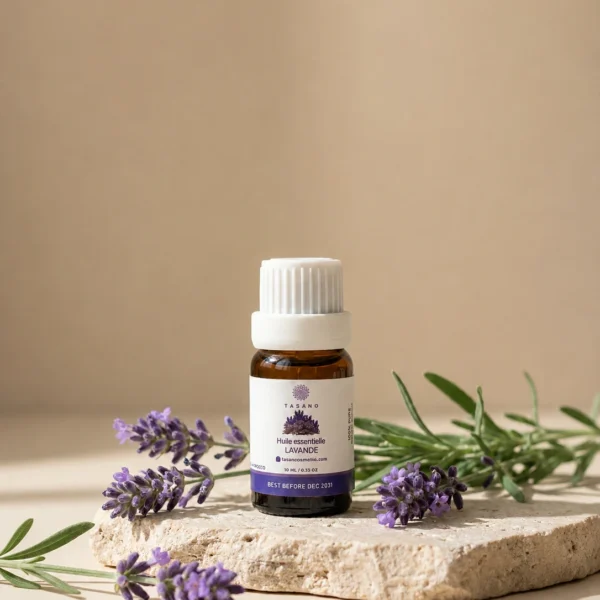 TASANO Lavender Essential Oil styled with fresh lavender, pale yellow oil drops, silk fabric, and beige stone.