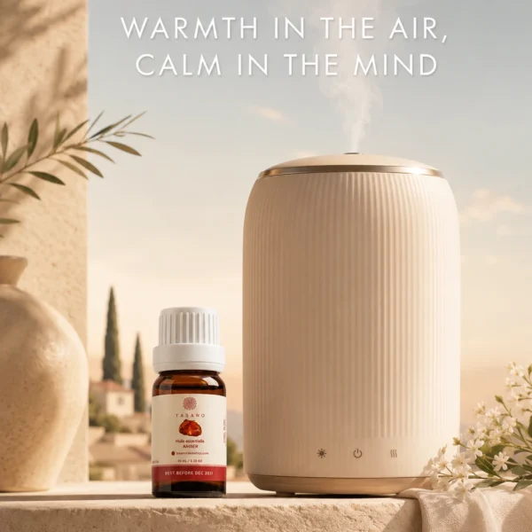 TASANO Amber Essential Oil beside an active diffuser for a warm, resinous Moroccan aromatherapy atmosphere at home.