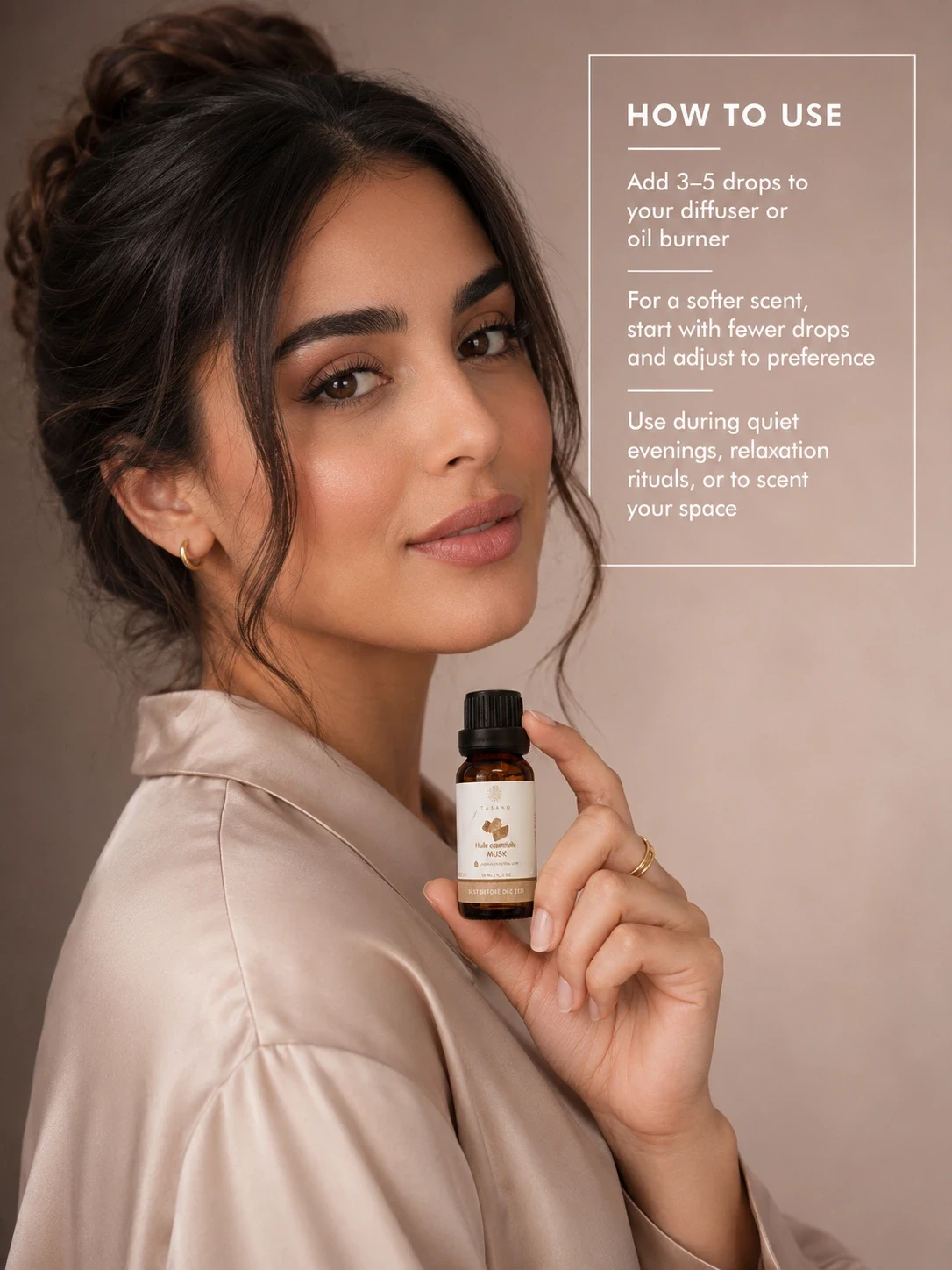 Moroccan model holding TASANO Musk essential oil with clear diffuser instructions showing how to add a few drops to water for a soft refined scent.