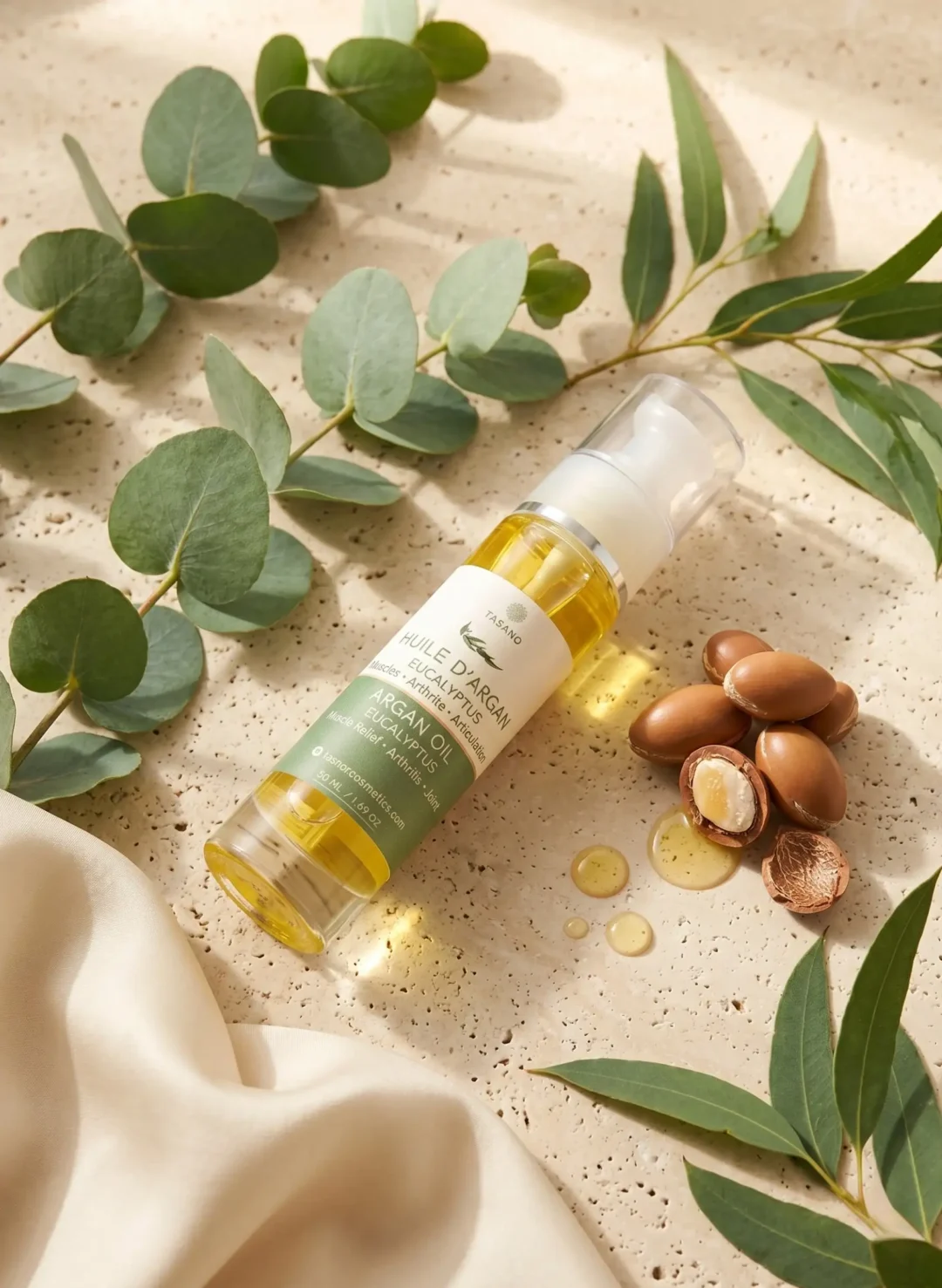 TASANO Eucalyptus Argan Body Oil bottle with eucalyptus leaves argan nuts and golden oil TASANO Eucalyptus Argan Body Oil bottle with eucalyptus leaves argan nuts and golden oil