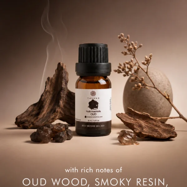 TASANO Oud essential oil bottle surrounded by oud wood elements on a deep warm background showing its rich woody, smoky and luxurious scent profile. TASANO Oud essential oil bottle surrounded by oud wood elements on a deep warm background showing its rich woody, smoky and luxurious scent profile.