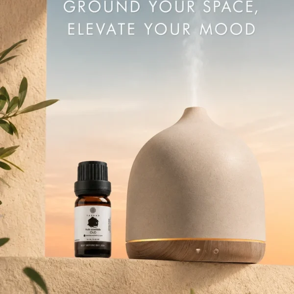 TASANO Oud Essential Oil beside an active diffuser for a deep woody Moroccan aromatherapy atmosphere.