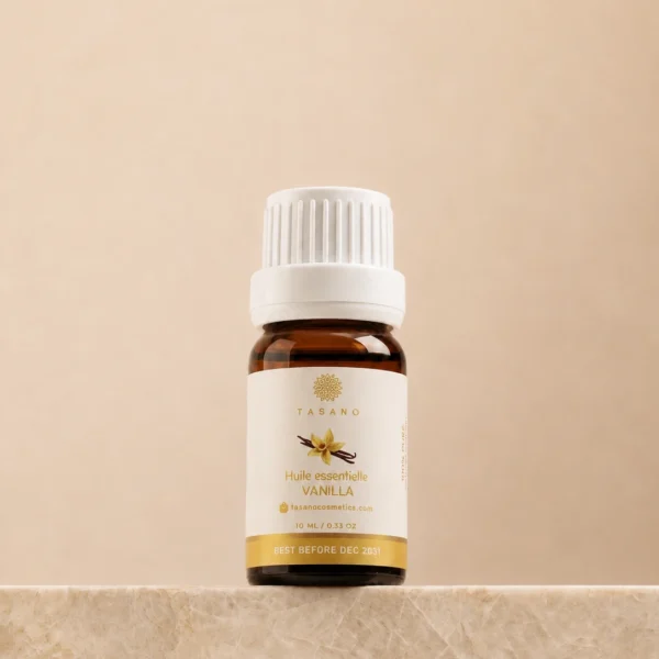 TASANO Vanilla Essential Oil 10 ml bottle on beige marble pedestal, Moroccan aromatherapy oil in amber glass.