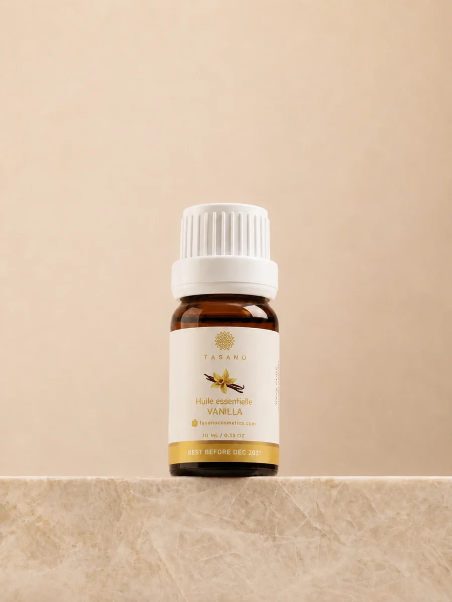 TASANO Vanilla Essential Oil 10 ml bottle on beige marble pedestal, Moroccan aromatherapy oil in amber glass.