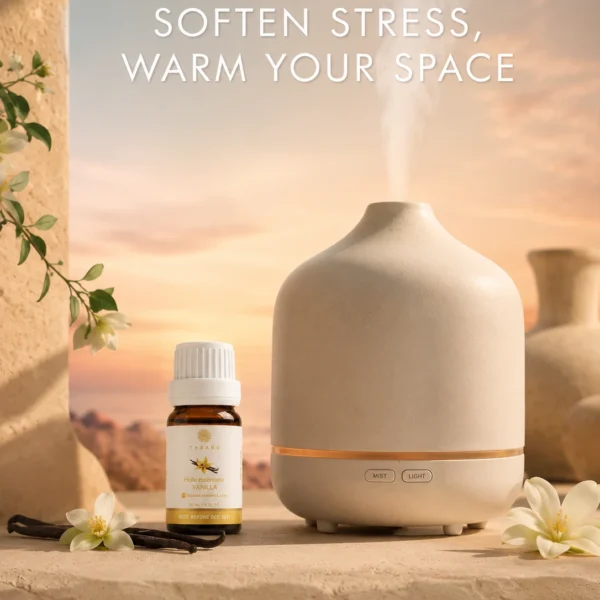 TASANO Vanilla Essential Oil beside an active diffuser for a warm, sweet, comforting aromatherapy atmosphere.